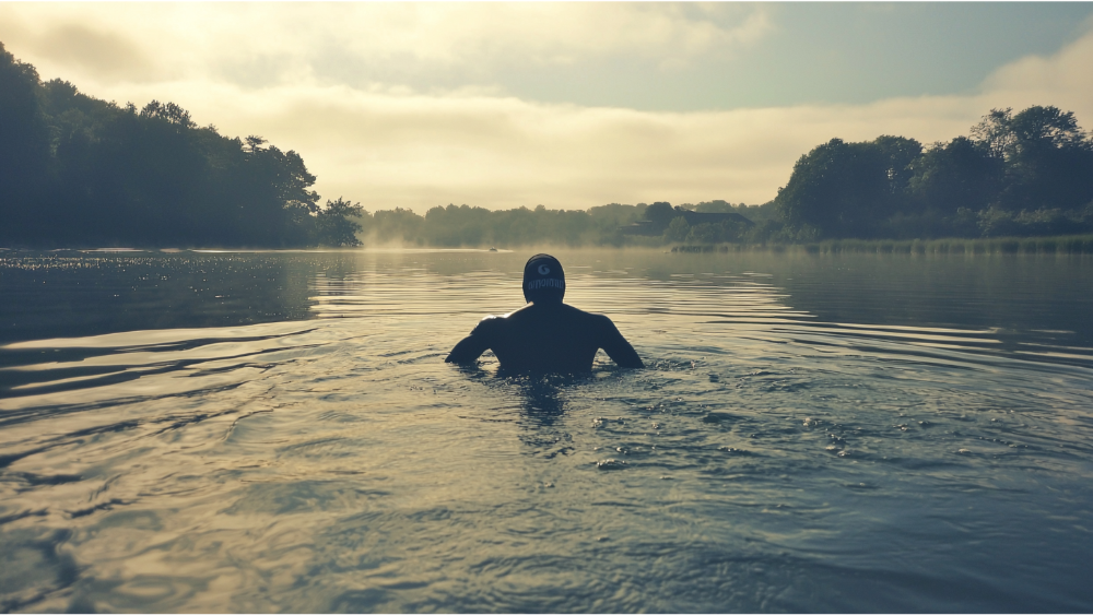 A man swimming in a lake