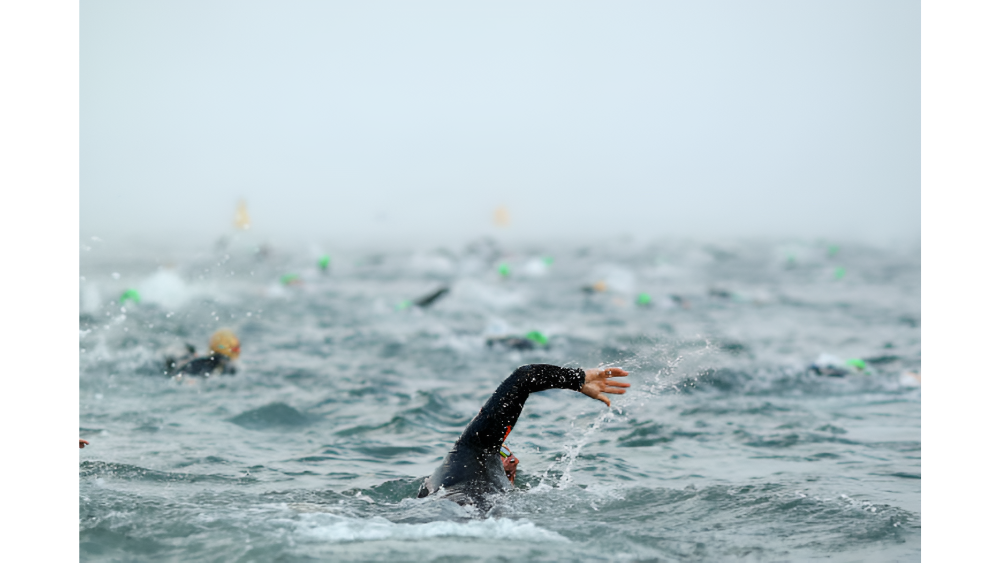 A man swimming freestyle during an Ironman